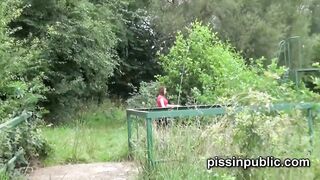 Peeing babes empty their bladders in a park