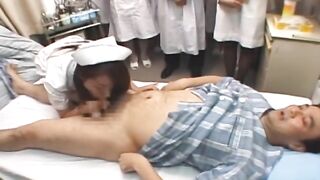Demonstration Day at Japanese Hospital Featuring a Group of Nurses Watching a Patient Being Milked Before Joining In