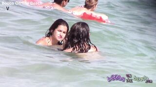 Two Italian girls playing under the water on the topless beach