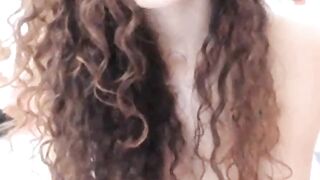 Curly brunette teen masturbates on webcam