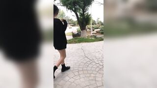 Chinese Girl Walking in a Park