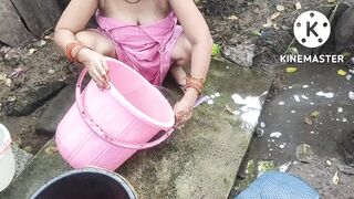 Indian house wife bathing outside