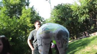 Hot raver chick in see-thru leggings and bra in the park