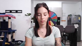 Sensual tattooed girl with an innocent appearance moves around