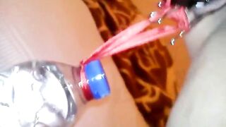 Slave lifts a water bottle with her pussy lips