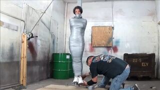 Busty woman duck taped to pole