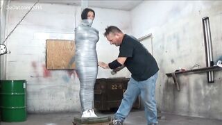 Busty woman duck taped to pole