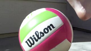 Zoom on beautiful feet playing in flat sandals & with ball.