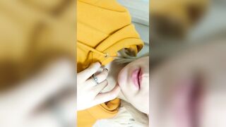 Home daytime striptease in a yellow hoodie. Close-up