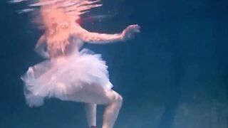 Bulava Lozhkova with a red tie and skirt underwater