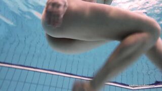 Swimming beauty totally naked and lonely in the pool