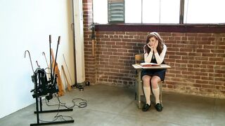 The cheeky schoolgirl is fooling around in the classroom with her percussion instruments.