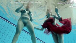 Two hotties submerged underwater