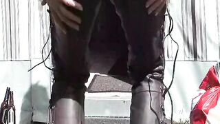 biker in leather pants pissing