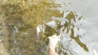 Lukerya walks by the river