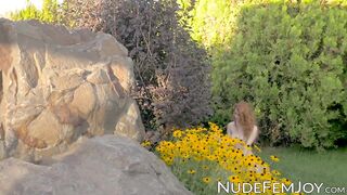 Young redhead sensually teasing in nature