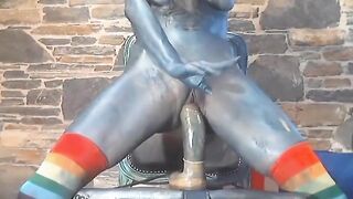 Sexy chick with body ink riding huge dildo