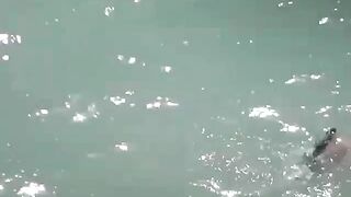 Fingering girls cunt on a beach