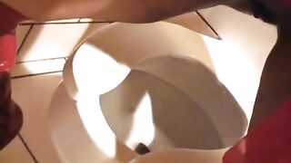 Watcher's view of two different ebony whores urinating in the bathroom