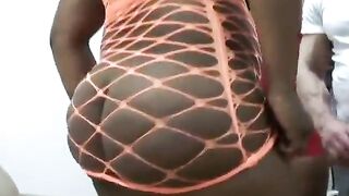 Big booty slut with orange fishnets poses for the camera