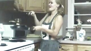 Slutty chick pokes her cunt with kitchen utensils on counter
