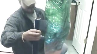Fetish chick loves being wrapped in green plastic with her shaved pussy