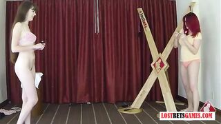 2 Pretty ladies play a game of strip darts