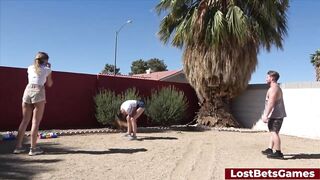 Two sexy girls are stripping down while playing volleyball in the backyard