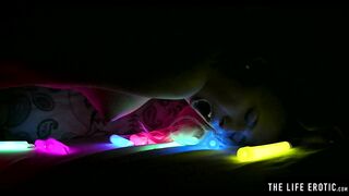Watch this hot blonde plunge glowsticks in her pussy and ass