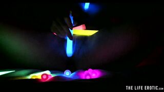 Watch this hot blonde plunge glowsticks in her pussy and ass
