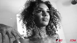 Beautiful tattooed ebony babe rubs her hairy pussy