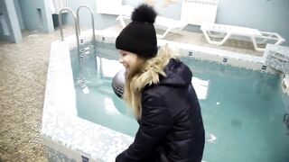 wetlook girl with winter clothes swims in the pool