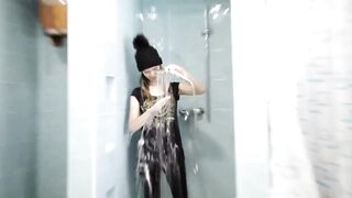 wetlook girl with winter clothes swims in the pool