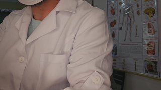 Gynecologist examines lesbian couple.