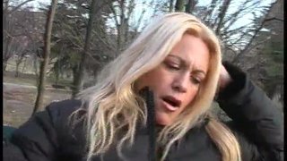 A blonde milf with amazing boobs flashing pussy and tits in a park