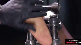 Black BDSM slave bound for foot domination