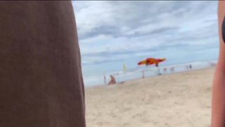 A milf jerk off a stranger on a public beach for a bet!