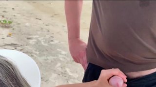 A milf jerk off a stranger on a public beach for a bet!