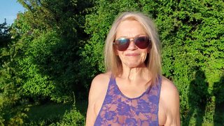 Granny is walking around her garden in a sheer bodysuit