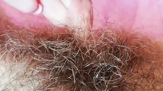 Extremely hairy pussy with big lips close-up